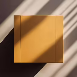 a brown box sits on a table as the shadows fall