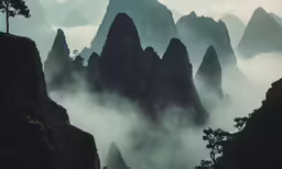 mountains with fog surrounding them with the word
