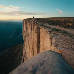 there is a man standing on a ledge and looking down