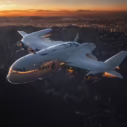 a large airplane flying over the ocean at sunset
