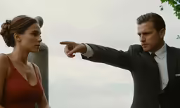 a woman pointing at a man with her hand out to the side