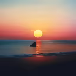 sunset over the ocean with sun reflecting in water