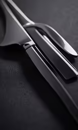 silver and black cutlers sitting on top of a table