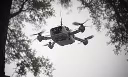 a large white and black remote control helicopter in the air