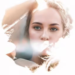 woman in profile looking directly at camera through light