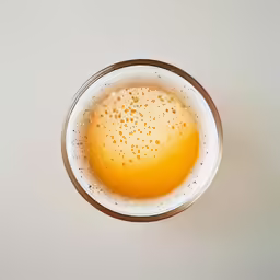 a glass of beer on a table with white background