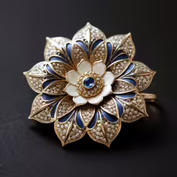 a flower brooch with stones on it