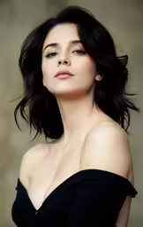 an elegant woman with a messy bobbin is posing for a photo