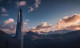 the top of a building with mountains in the background