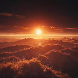 the sun is setting over a mountain range