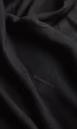 the fabric is black with a metallic texture