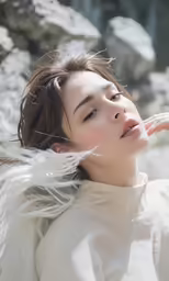 young female model with white feathers on her head