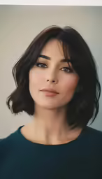 an asian woman with dark brown hair, blue eyes and dark green dress