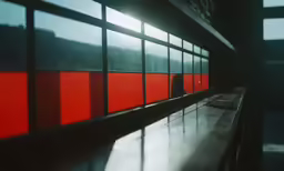 red and black lines on a window in a dark room
