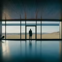 man in black standing in front of a doorway