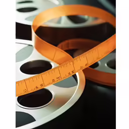 measuring tape and film reels that are black and white