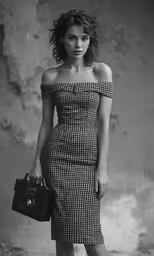 a woman holding a camera next to a building