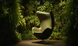 a egg chair is illuminated by an array of plants