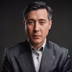 a man poses for a picture in a suit