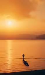a person riding a surfboard into the ocean at sunset