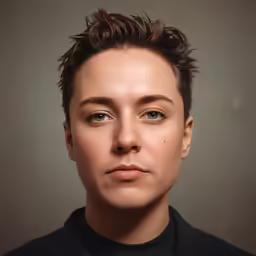 a man with very short hair and a black shirt