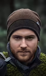a man with a red beard in a brown cap
