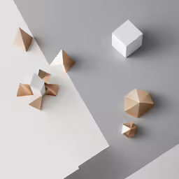 four pieces of shiny metal on a gray background