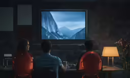 a group of people watching a large mountain