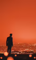 a man is standing on top of a building at night