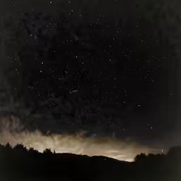a black and white photo of stars at night