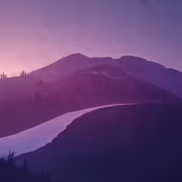 the mountains are covered in snow at dusk