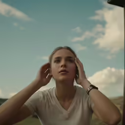 a young woman listening to music in a countryside