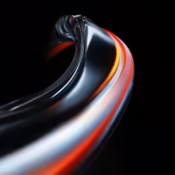 an abstract photograph of a curved orange line on a black background