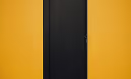 an empty bathroom with a black and yellow toilet