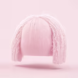 a pink knitted hat with fringes sits on the floor