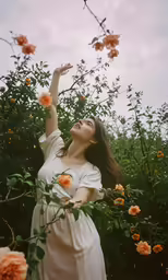 a woman standing on the ground, in the midst of flowers