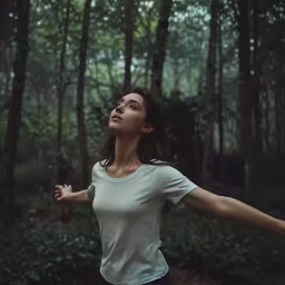 woman tossing her arms wide in the air