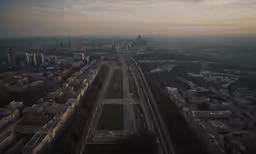 an aerial view of a freeway through a city with tall buildings