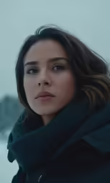 a woman with cold weather clothing and a scarf