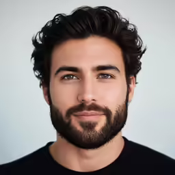 a man with a beard and a black shirt looks to the side