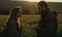 a young man and a woman staring into each others eyes