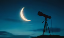 a photographer taking a photograph of the moon, through a telescope