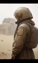 a man wearing a brown trench coat and helmet standing in a barren area