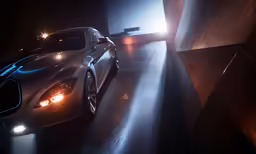a silver sports car in a dark garage