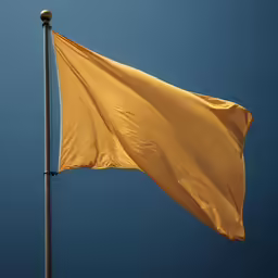 yellow kite is flying above against a dark blue sky