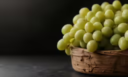 a basket full of white grapes is sitting on the table