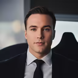 a man in a suit and tie staring away from the camera