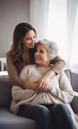 two women embracing each other on a couch