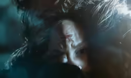 a man with long hair and a creepy look on his face