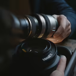 someone holding a camera with a lens and a case